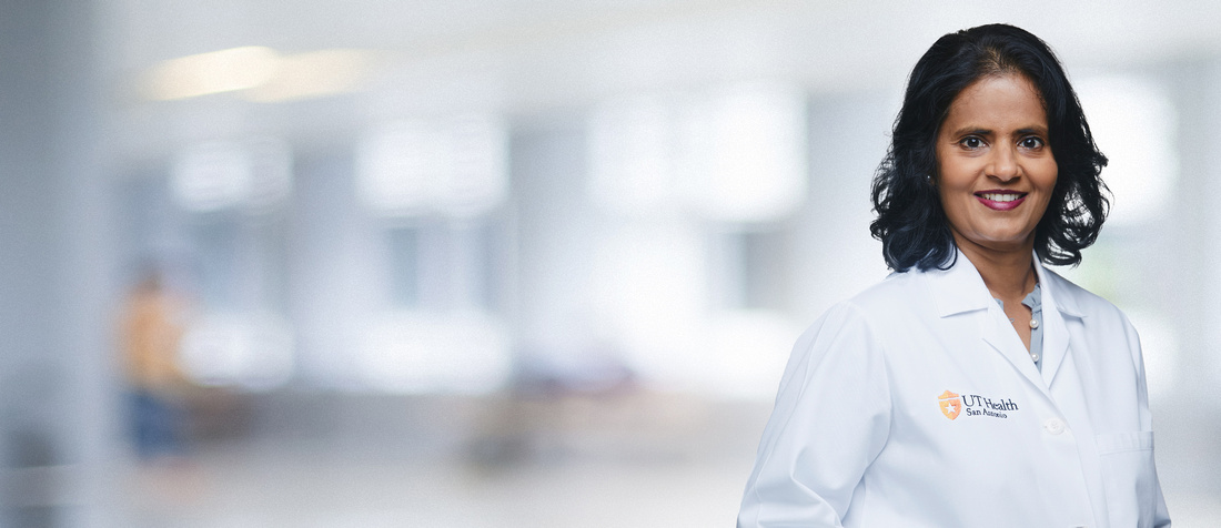 A photo of Dr. Perepu in a white coat
