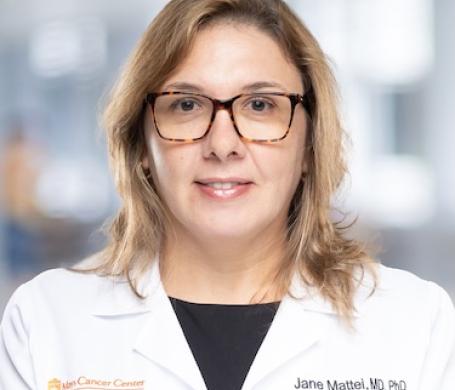 Dr. Jane Mattei in a white coat, smiling for a photo.
