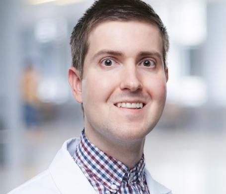 A headshot of Dr. Robert Christopher Gilson in his white coat